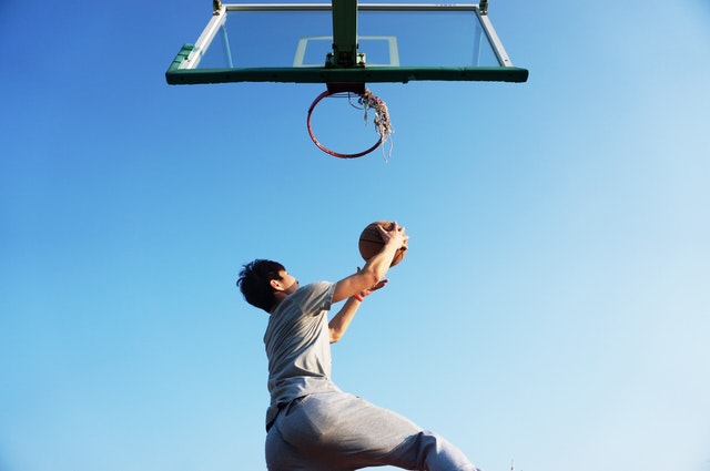 Get-your-family-fit-man-shooting-ball-at-basketball-hoop