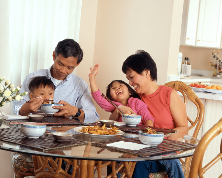 family-sat-at-a-table-laughing