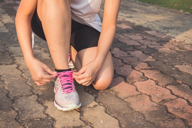 get-your-family-fit-woman-bending-down-tying-running-trainer-lace