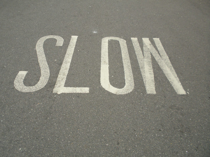 Slow down road sign