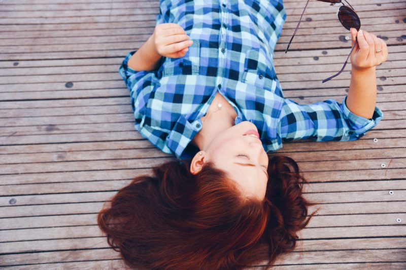 Woman lying on decking
